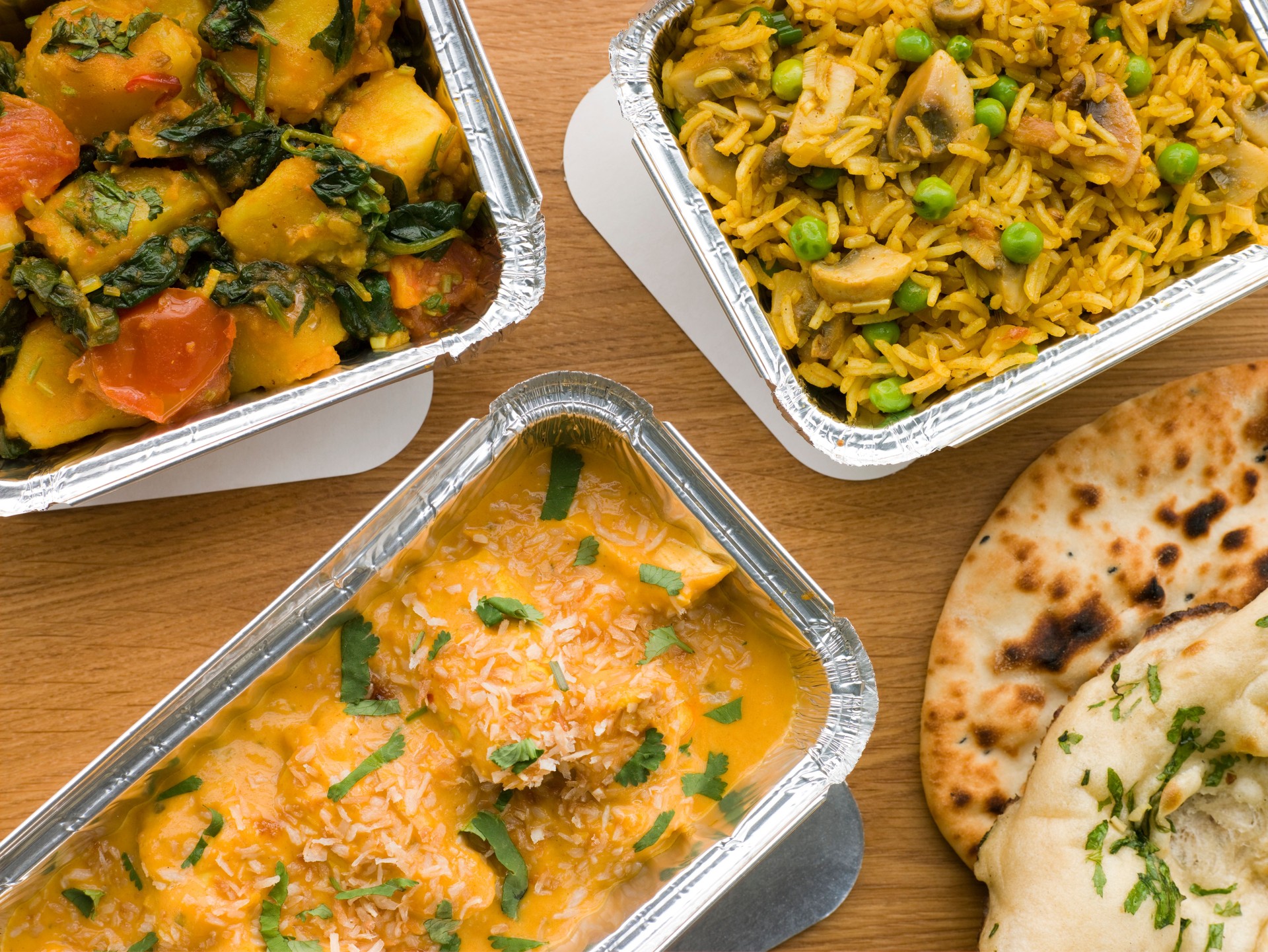 Selection Indian Take Away Dishes In Foil Containers